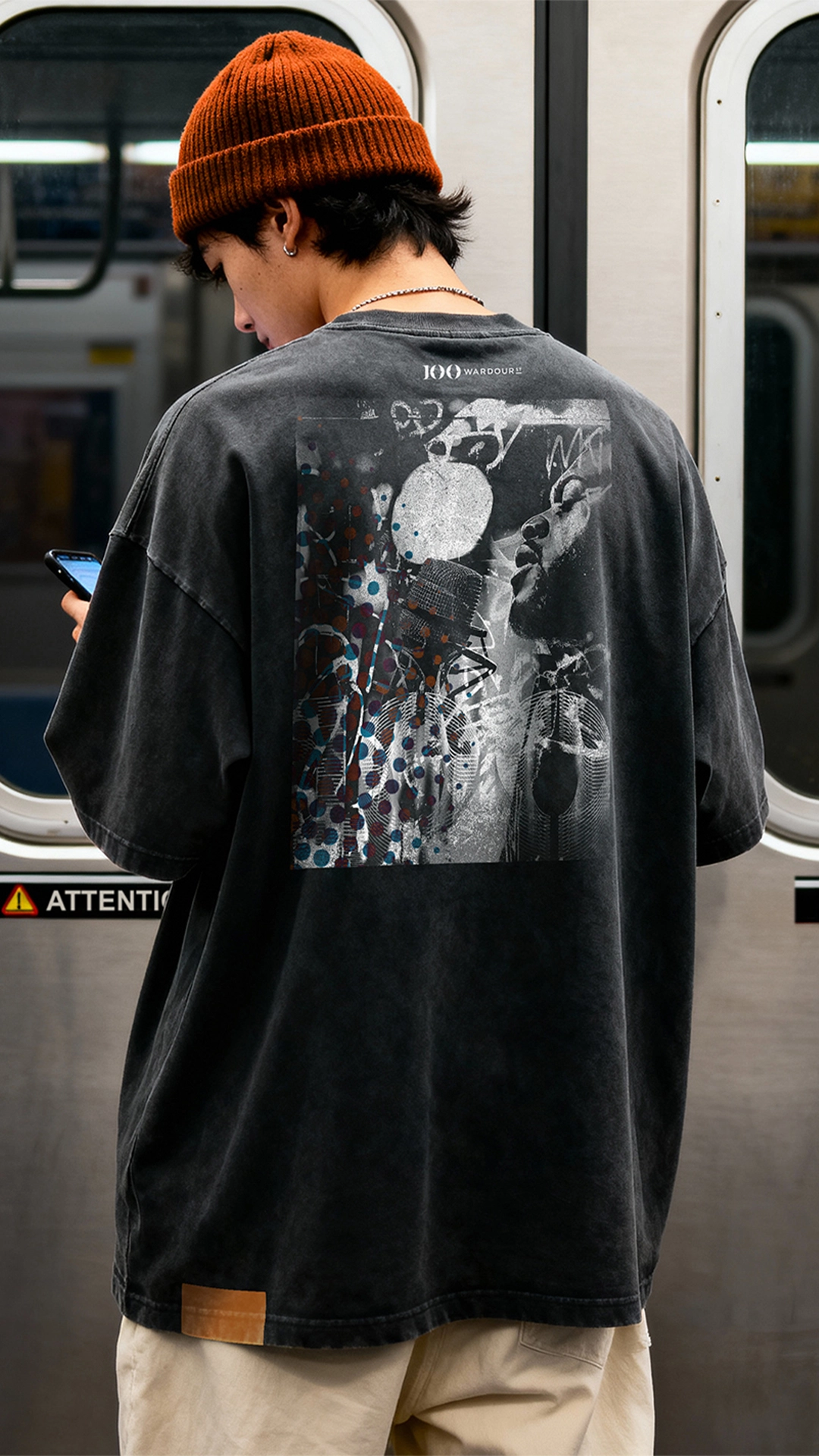 Person wearing a t shirt with a design for 100 Wardour Street