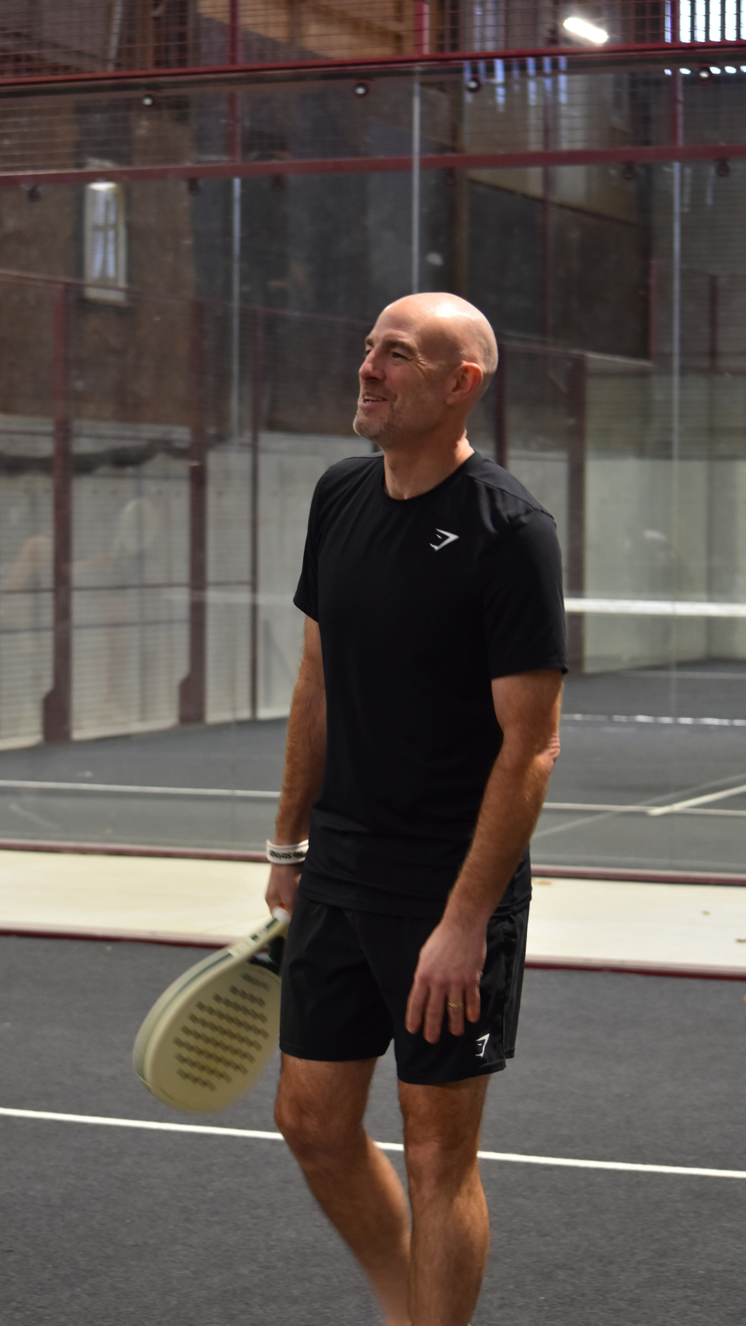Ian laughing playing padel