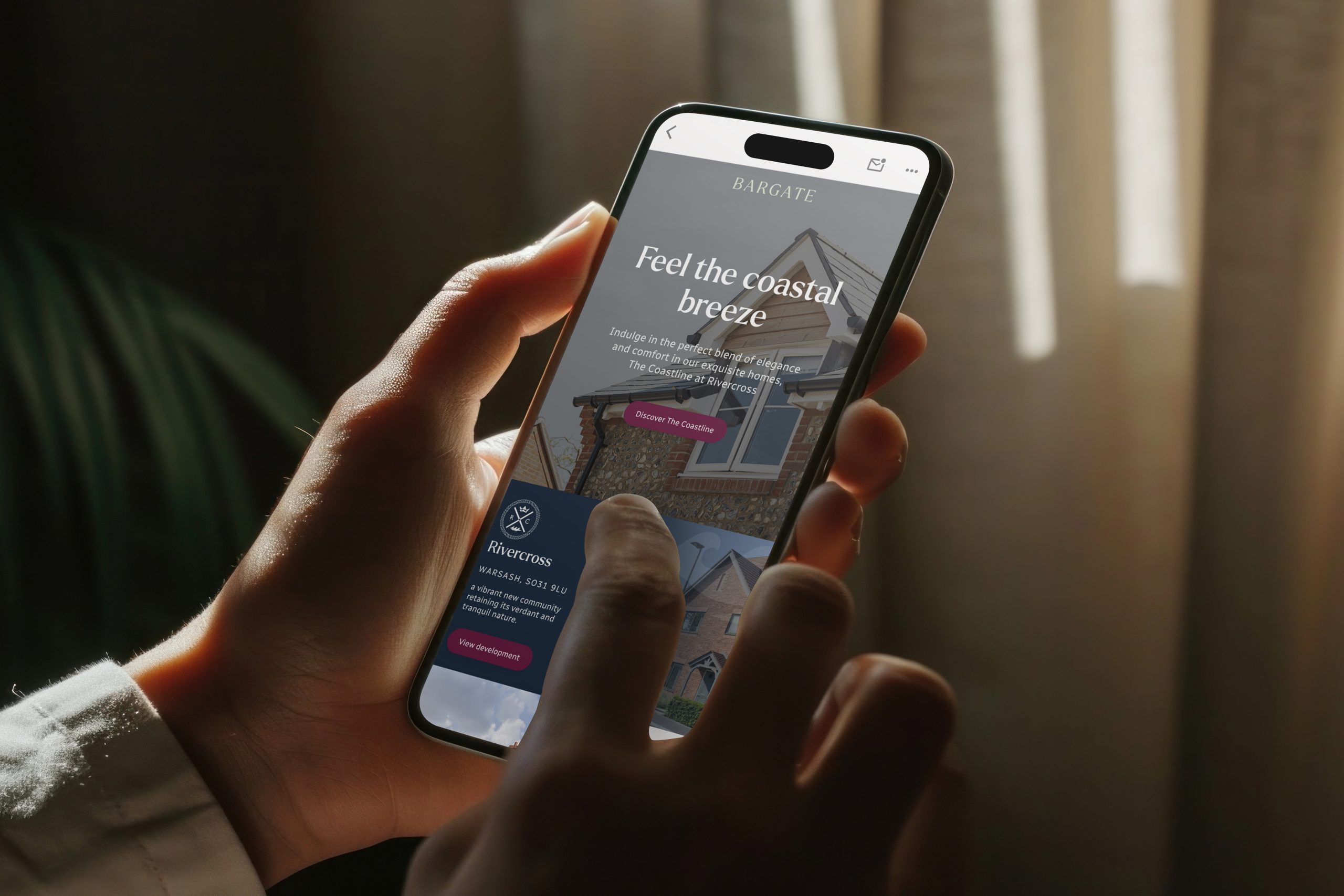 Person using mobile phone showing the Bargate website